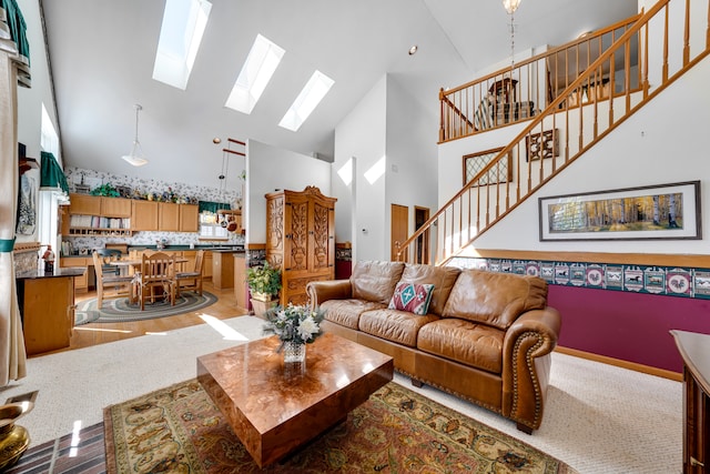 living room featuring a healthy amount of sunlight, high vaulted ceiling, and light wood-type flooring