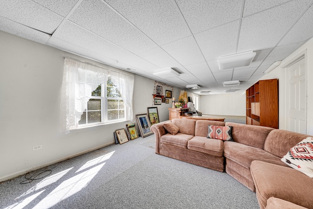 carpeted living room with a drop ceiling