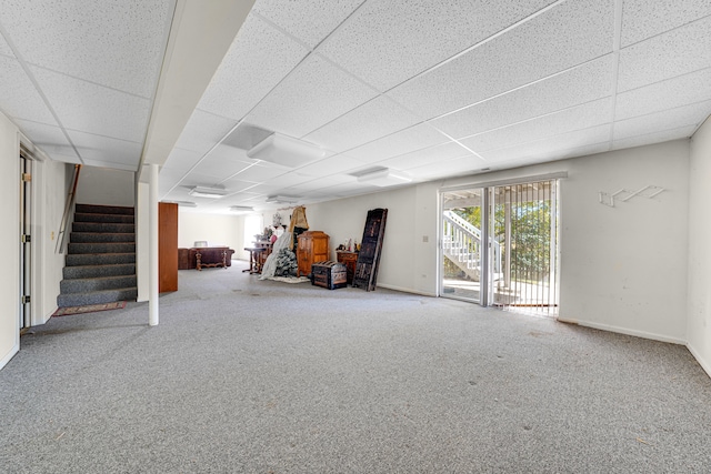 basement with carpet flooring and a paneled ceiling