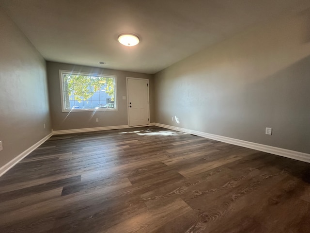 unfurnished room with dark hardwood / wood-style flooring