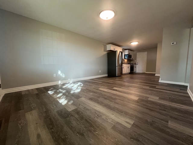 unfurnished living room with dark hardwood / wood-style flooring