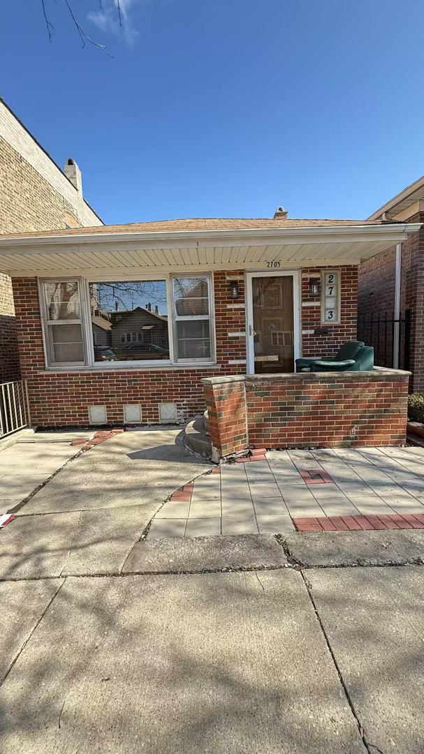 property entrance featuring brick siding