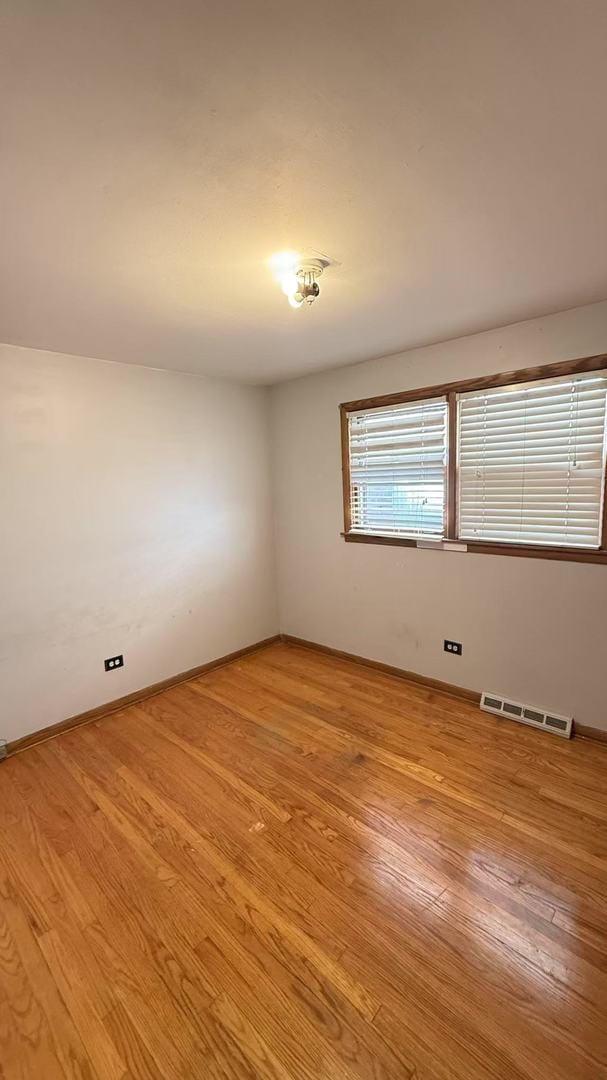 empty room with visible vents and light wood-style floors