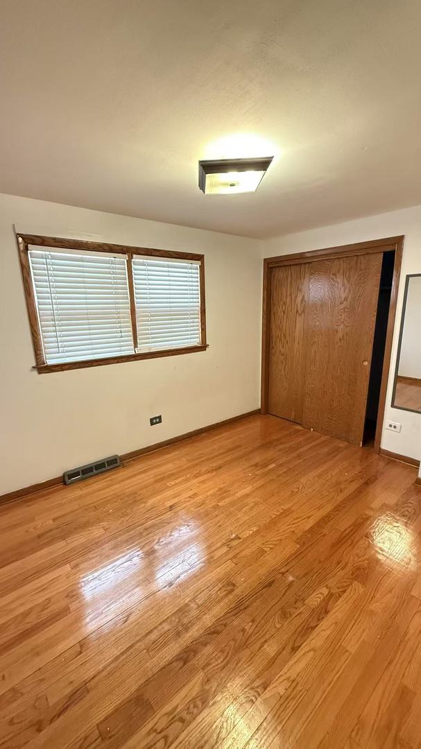 spare room with light wood-type flooring and visible vents