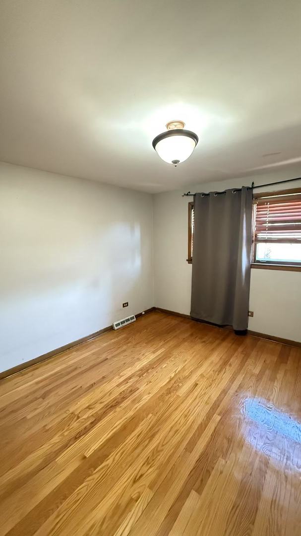 spare room with light wood-type flooring and visible vents