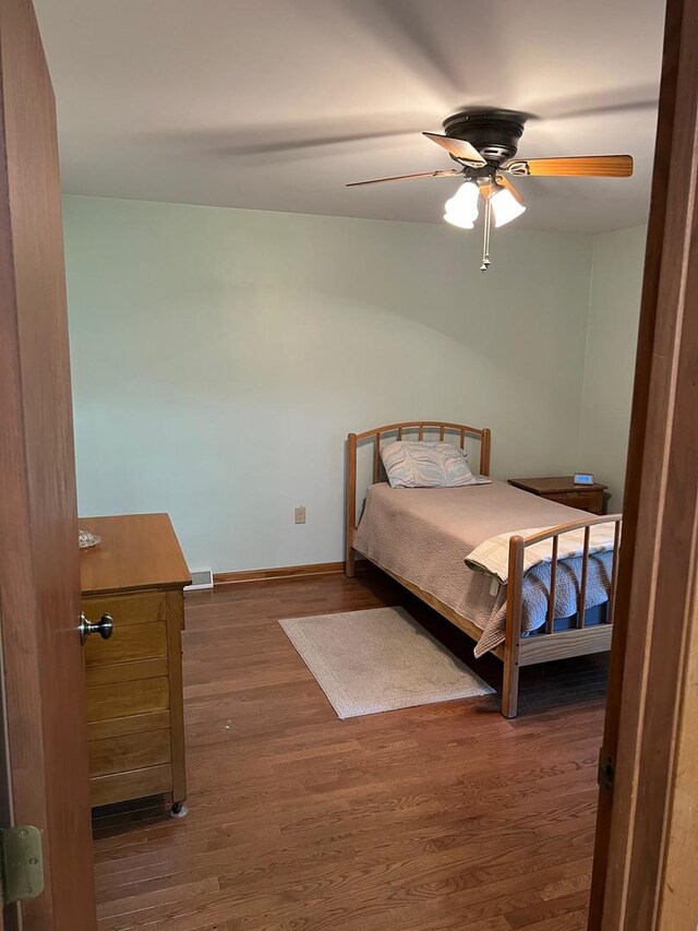 bedroom featuring dark hardwood / wood-style flooring and ceiling fan