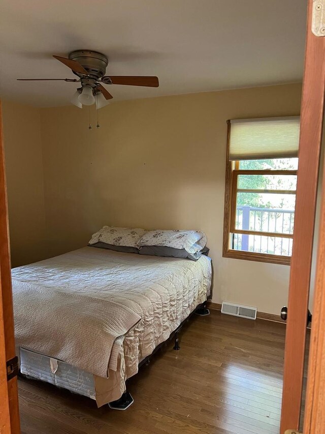 bedroom featuring ceiling fan and dark hardwood / wood-style flooring