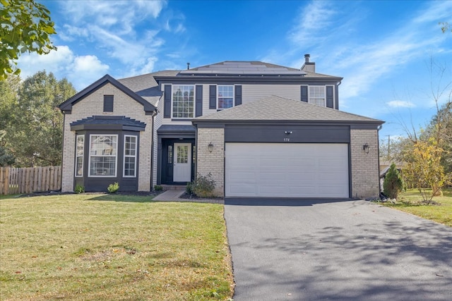 front facade featuring a garage and a front lawn