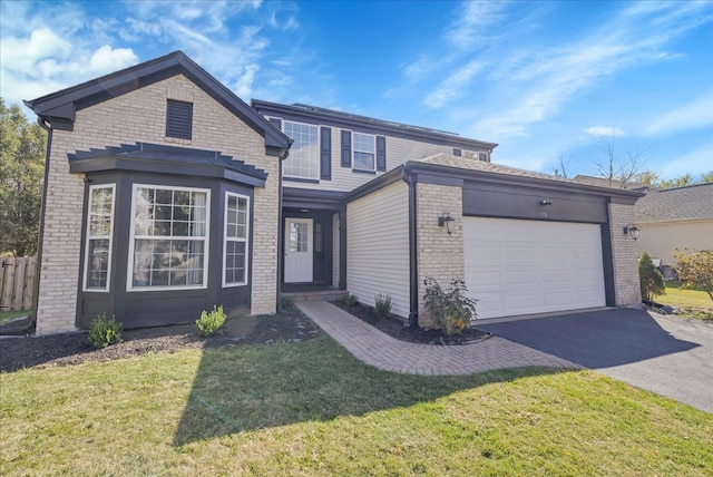 view of front of home with a front lawn and a garage