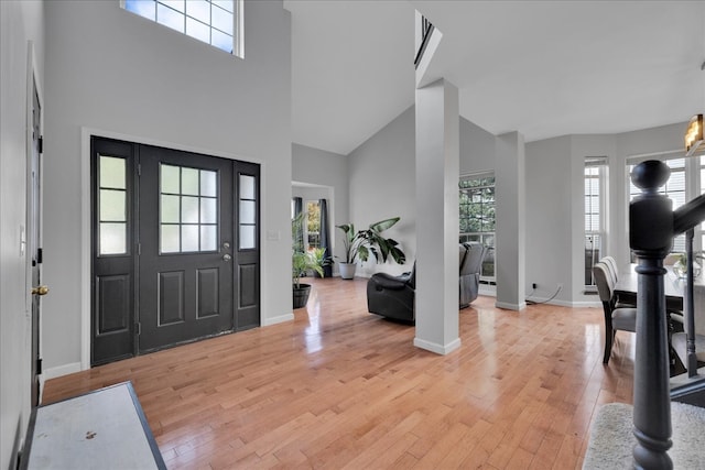 entrance foyer featuring a high ceiling and light wood-type flooring