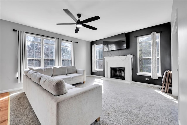 living room featuring ceiling fan, light hardwood / wood-style floors, and plenty of natural light