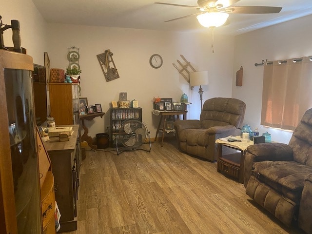 living room with light wood-type flooring and ceiling fan