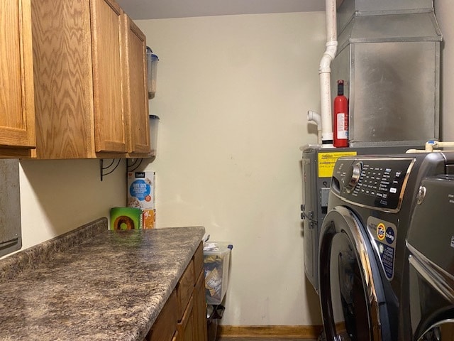 laundry area with washer / clothes dryer and cabinets