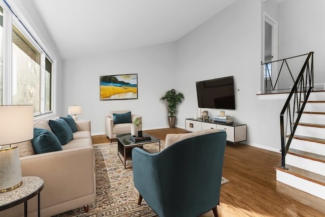 living room with wood-type flooring and lofted ceiling