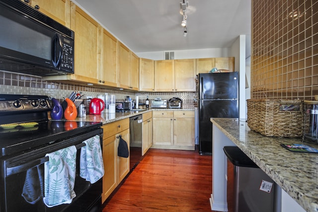 kitchen featuring tasteful backsplash, black appliances, dark wood-type flooring, and light stone counters