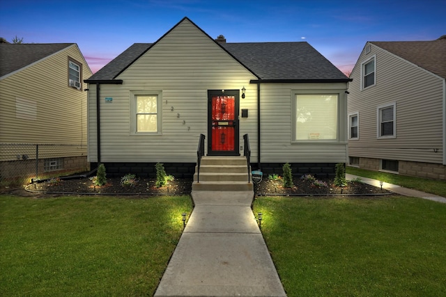 bungalow featuring a yard