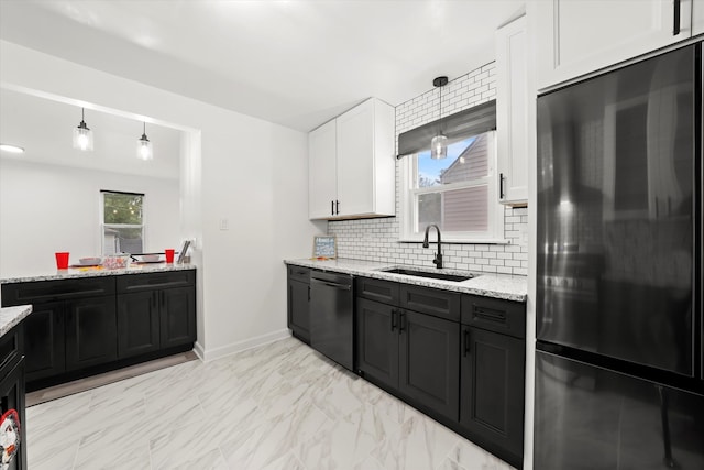 kitchen featuring white cabinets, stainless steel dishwasher, black refrigerator, pendant lighting, and sink