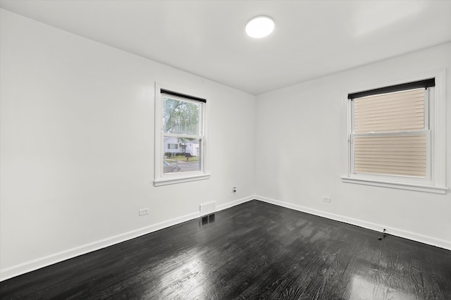 empty room with dark wood-type flooring