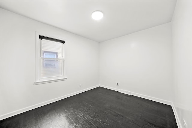 spare room with dark hardwood / wood-style flooring