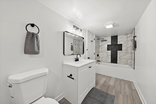 full bathroom featuring vanity, toilet, hardwood / wood-style flooring, and tiled shower / bath combo