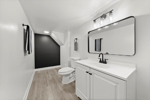 bathroom with vanity, hardwood / wood-style floors, and toilet