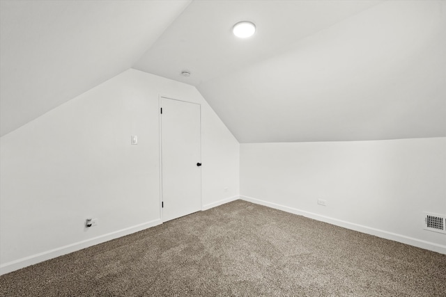 additional living space featuring lofted ceiling and carpet floors