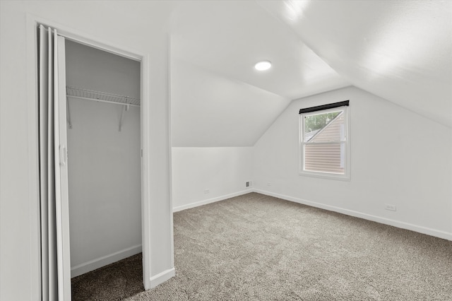 bonus room with lofted ceiling and carpet