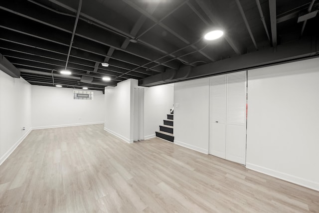 basement with light hardwood / wood-style floors