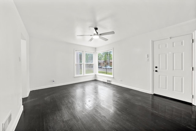 unfurnished room with ceiling fan and dark hardwood / wood-style flooring