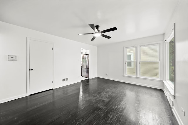 unfurnished room with ceiling fan and dark hardwood / wood-style flooring