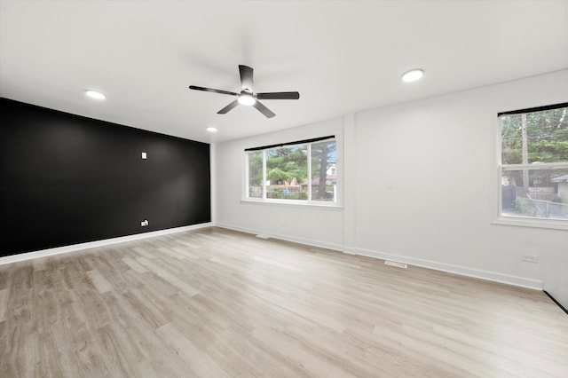 unfurnished room with light hardwood / wood-style floors, plenty of natural light, and ceiling fan