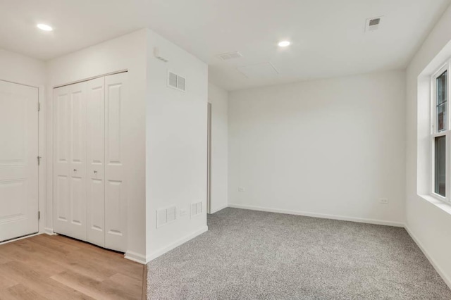 unfurnished bedroom with light wood-type flooring