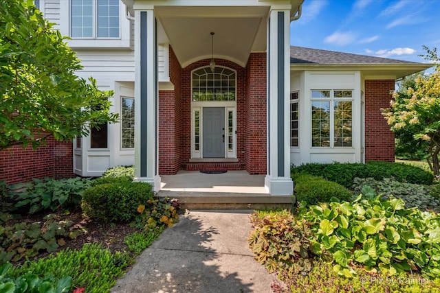 view of exterior entry with covered porch