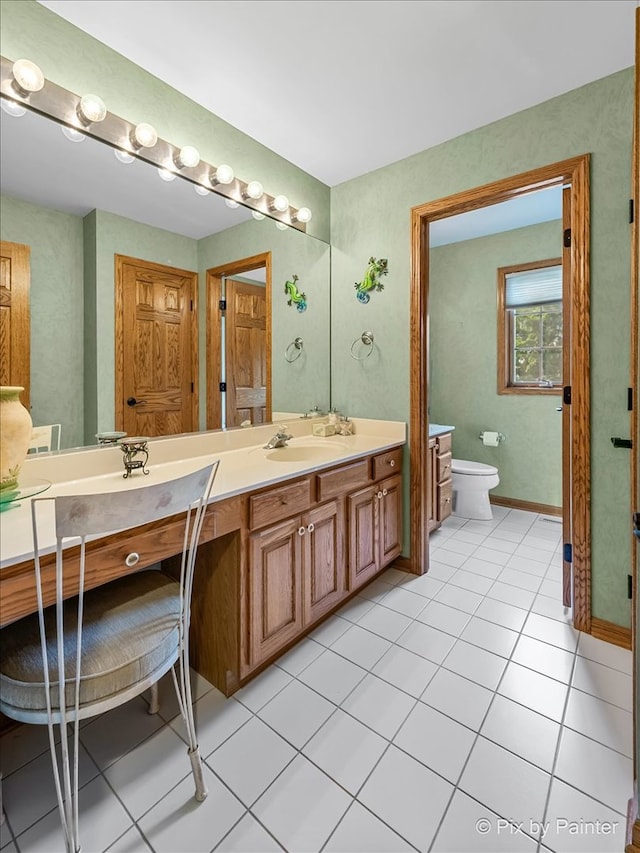 bathroom with vanity, toilet, and tile patterned floors