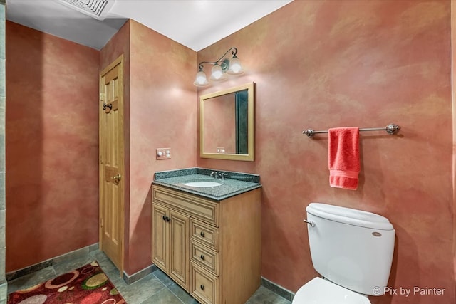 bathroom featuring vanity, toilet, and tile patterned floors