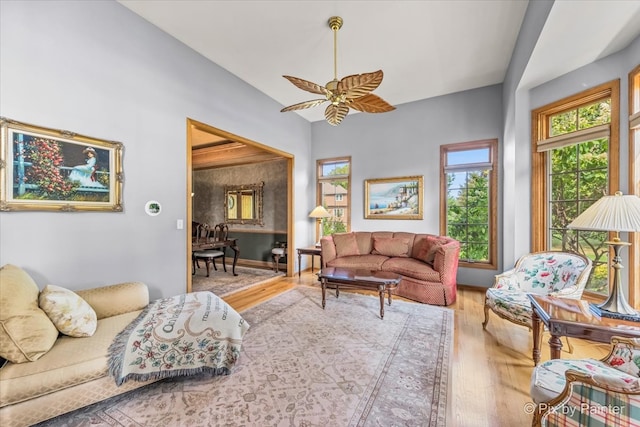 living room with ceiling fan and light hardwood / wood-style flooring