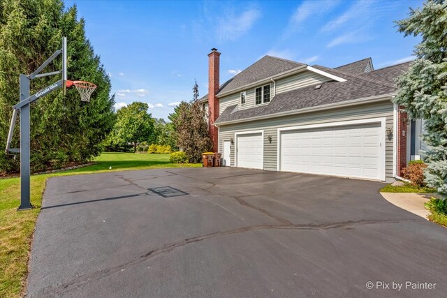 exterior space with a yard and a garage