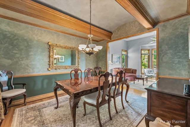 dining room with beamed ceiling, crown molding, ceiling fan with notable chandelier, and light hardwood / wood-style floors