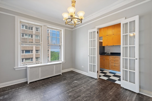 unfurnished dining area featuring radiator, sink, crown molding, a chandelier, and dark hardwood / wood-style flooring