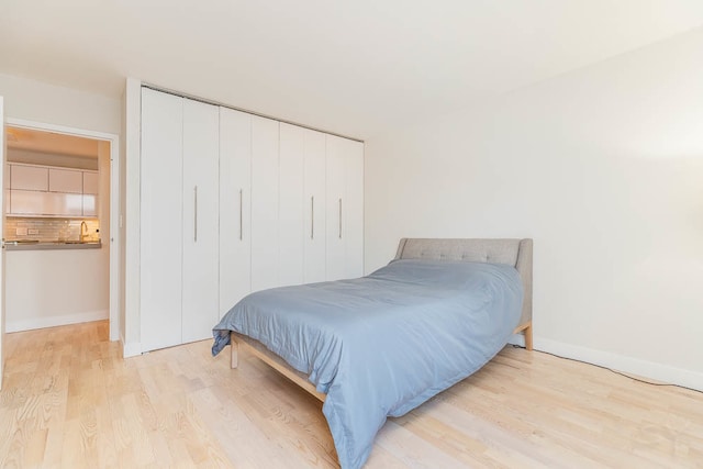 bedroom featuring a closet and light hardwood / wood-style floors