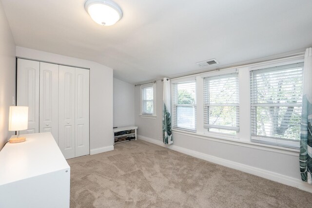 bathroom with a shower with door, tile patterned flooring, and vanity