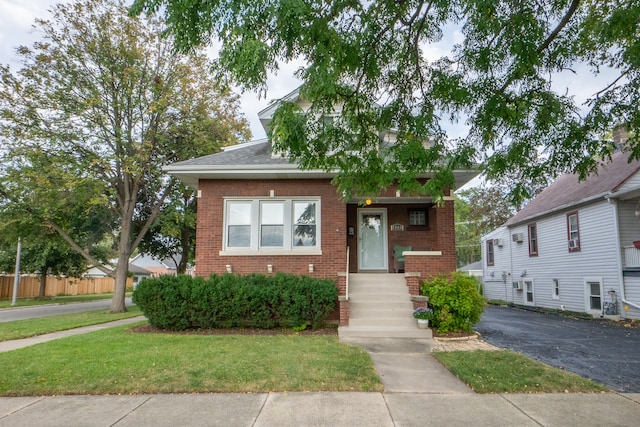 bungalow-style home featuring a front lawn