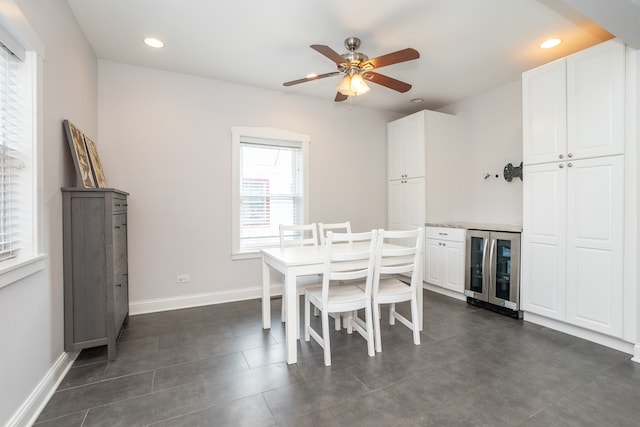 tiled dining space with beverage cooler and ceiling fan