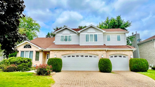 view of front of house featuring a front lawn and a garage