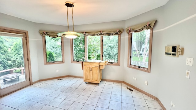 unfurnished dining area featuring light tile patterned flooring