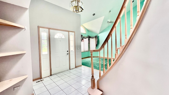 foyer entrance featuring a notable chandelier and light tile patterned flooring