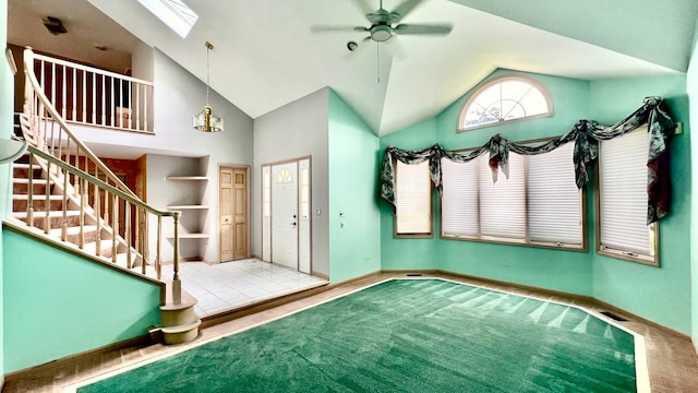 entryway with light carpet, vaulted ceiling, and ceiling fan with notable chandelier