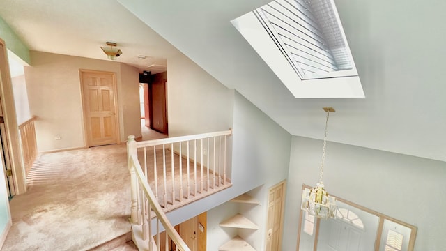 corridor featuring a skylight and carpet floors