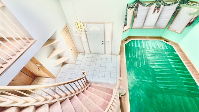 stairs featuring a high ceiling and tile patterned flooring