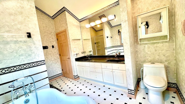 bathroom with tile patterned floors, a tub to relax in, toilet, crown molding, and vanity